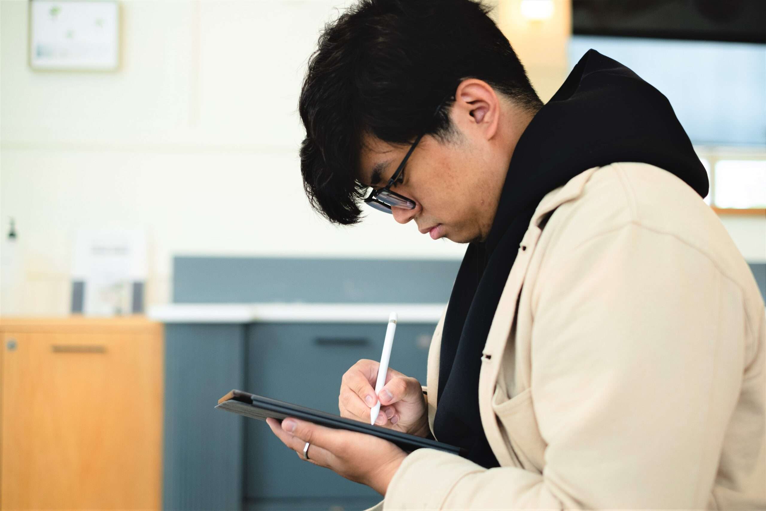 a student with low vision using a tablet. Close-up. highlighting teamwork and collaboration in a modern office setting.